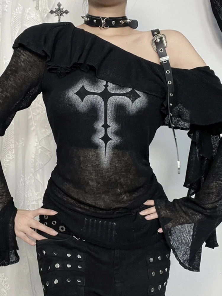 Close front view of cross print, shoulder buckle and ruffle neckline