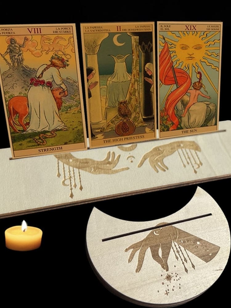 Beige wooden tarot card stand pair with hanging charm and hand motifs, holding upright cards in a rectangle and moon-shaped base.