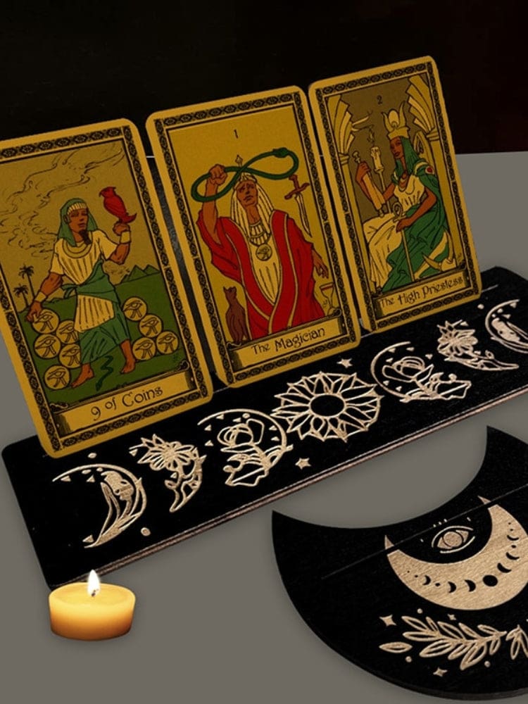Black rectangle and moon-shaped tarot card holders displaying cards, with pale celestial artwork around the narrow slots.
