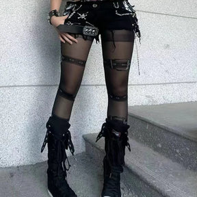 Black buckle print tights styled with shorts and tall boots, showing the punk belt pattern along the legs.