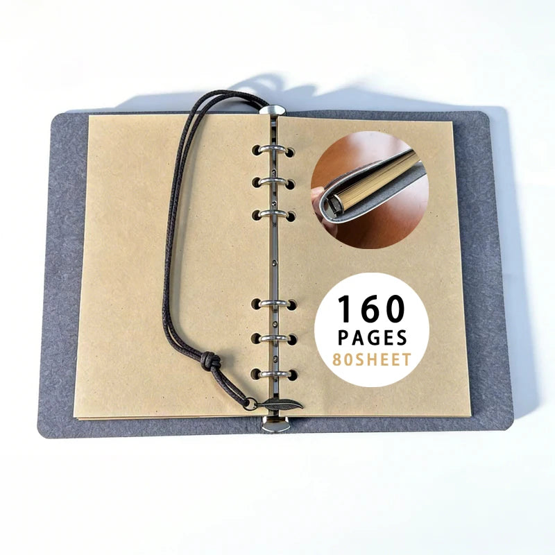 Refillable gothic journal opened to plain brown paper and six binder rings, with a close-up of the ring mechanism and page-count label.