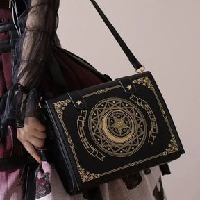 Angled view of black gothic book bag with gold-tone celestial artwork