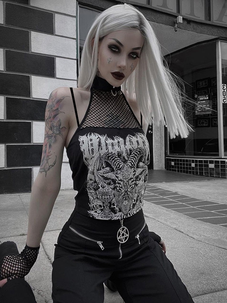 Black crop top with white horned-goat artwork, a fishnet chest panel and choker-style neck, worn with black trousers against a tiled wall.