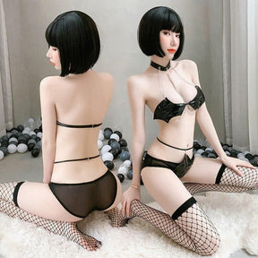 Black lace lingerie set with bow detail and matching thong paired with fishnet stockings in black bat wing costume set