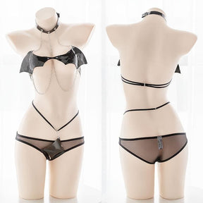 Black bat wing costume set featuring black bat wing latex lingerie with sheer mesh and chain detailing
