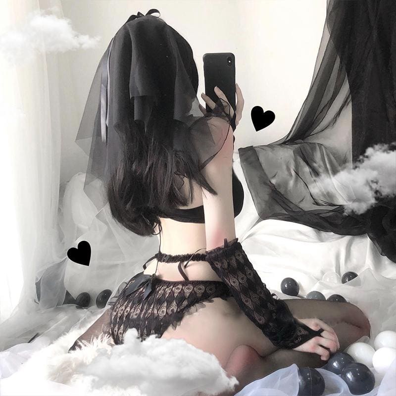 Rear view of the black bridal set, showing the short sheer veil, open strappy waist detail and lace briefs beside the long lace sleeves.