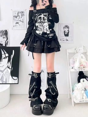 Standing front view of loose black gothic leg warmers with zipper accents, buckles and wide lower openings.