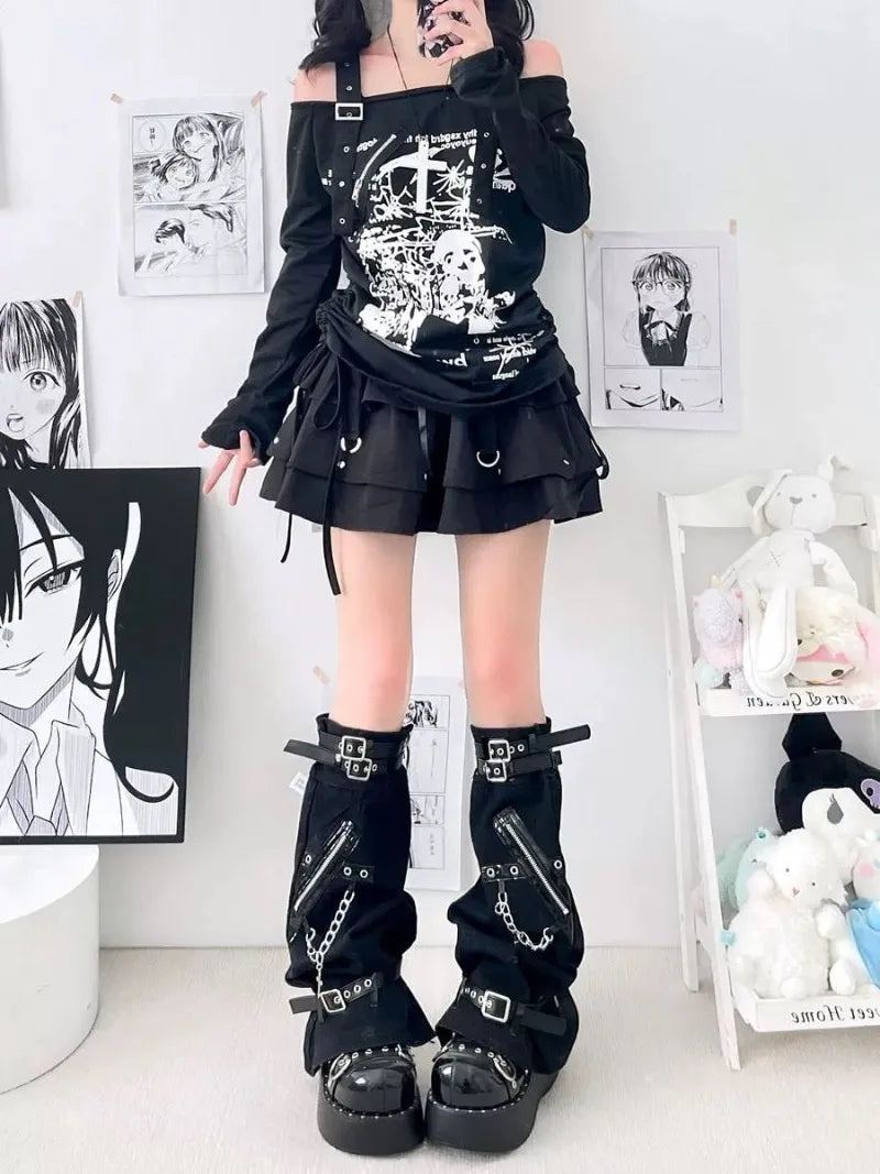 Standing front view of loose black gothic leg warmers with zipper accents, buckles and wide lower openings.