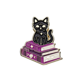 Black cat sitting on two purple spellbooks, with tiny stars on its body and celestial and skull details on the book spines.