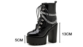 Glossy black chain platform boot with arrows showing a 5cm platform and 13cm heel.