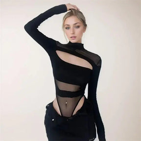 Front view of a black mesh cutout bodysuit with one arm raised, showing the sheer shoulders, curved chest opening and opaque bands across the torso.