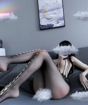 Reclining side view of the black bodystocking showing the finer mesh along the backs and sides of the legs.