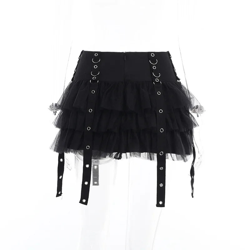 Rear view of the black ruffle skirt on a clear mannequin, showing the back waistband and hanging eyelet straps.