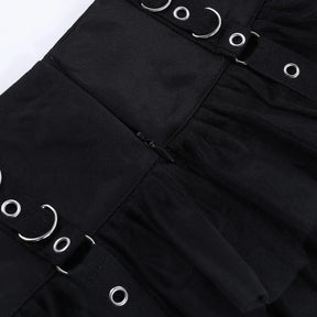 Close-up of the black skirt's rear zipper between the waistband panels, with ring details visible on either side.