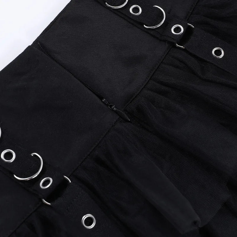 Close-up of the black skirt's rear zipper between the waistband panels, with ring details visible on either side.