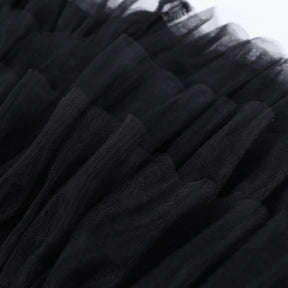 Close view of the black skirt's fine mesh ruffles, showing the gathered texture and overlapping layers.