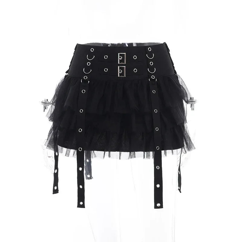 Straight front view of the black ruffle skirt on a clear mannequin, with two rectangular waistband buckles above the mesh tiers.