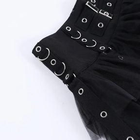 Close-up of the black skirt's broad waistband with rectangular buckles, curved silver-tone rings and small eyelets.