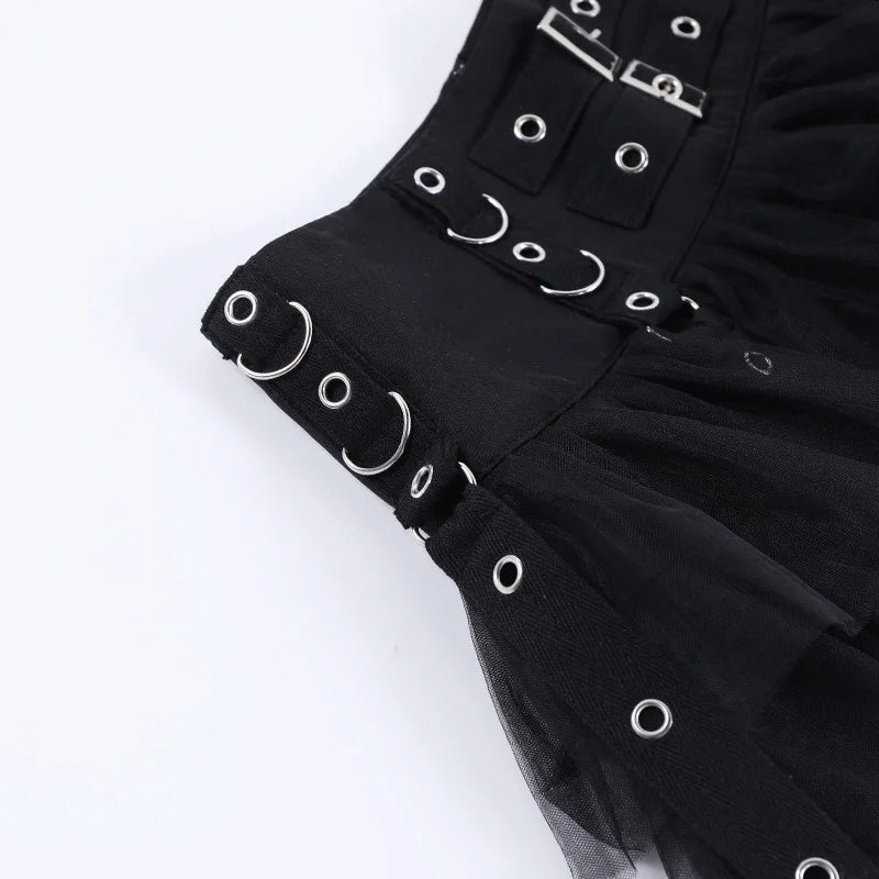 Close-up of the black skirt's broad waistband with rectangular buckles, curved silver-tone rings and small eyelets.