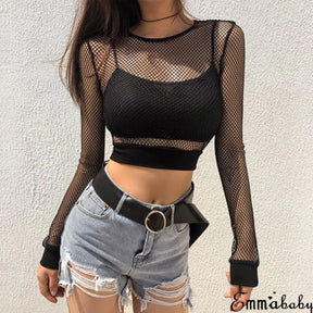 Black fishnet crop top worn over a black bralette with belted denim shorts, showing the long sleeves, round neckline and wide hem band.