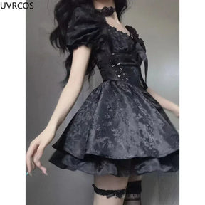 Side view of the black gothic mini dress, highlighting ribbon lacing through silver-tone eyelets, a puff sleeve and the flared floral jacquard skirt.