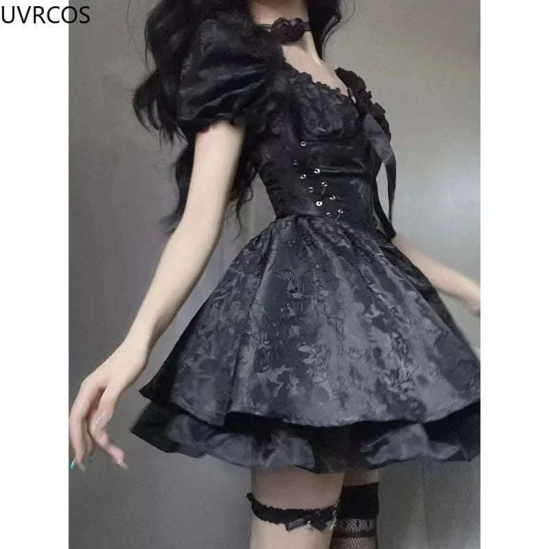 Side view of the black gothic mini dress, highlighting ribbon lacing through silver-tone eyelets, a puff sleeve and the flared floral jacquard skirt.