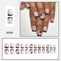 Short pink square nails with black French tips, white spiderwebs and tiny black spiders, shown worn and laid out by size.