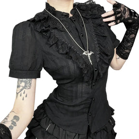Black gothic blouse with ruffle-trimmed stand collar on a plain background