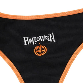 Close-up of white Halloween lettering and an orange pumpkin motif on the black ribbed thong front.