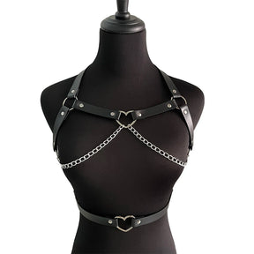 Full front view of the black chest harness and separate waist belt on a black mannequin, with both silver-tone heart rings and chain loops visible.