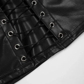 Lower front detail of the black lace-up top, showing eyelets, crossed cords and the stitched cropped hem.