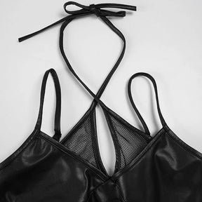 Black halter ties arranged in a bow above the mesh keyhole neckline, with both shoulder straps visible on white.