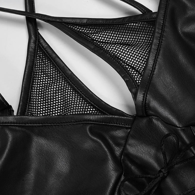 Close-up of the black top's sheer mesh panels surrounding the narrow keyhole opening and edged with glossy trim.