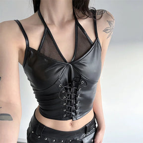 Close model view of the black halter crop top with the ties arranged uncrossed, showing its mesh neckline and front lacing.