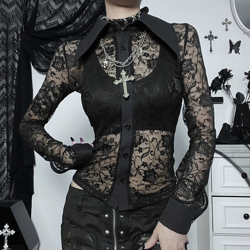 Black collared lace blouse worn over a black underlayer, with one hand at the waist and the other arm showing its floral sheer sleeve.