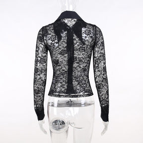 Rear mannequin view of the black lace blouse, showing the transparent floral back, centre seam and long sleeves.