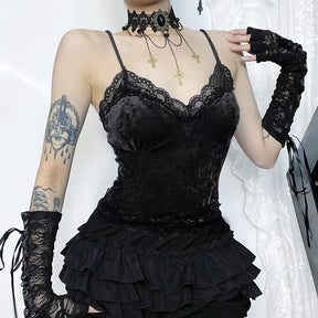 Angled front view of the black lace-trim camisole worn with a ruffled skirt and long floral lace arm warmers.