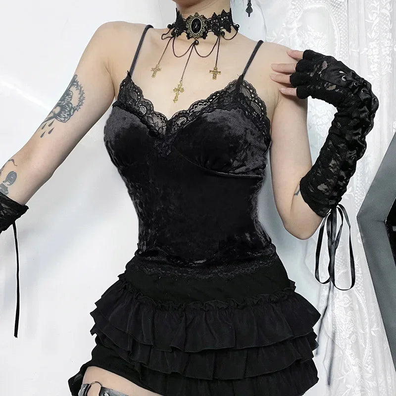 Front view of the black lace-trim camisole, showing the dipped neckline and curved bust seams with a ruffled skirt below.