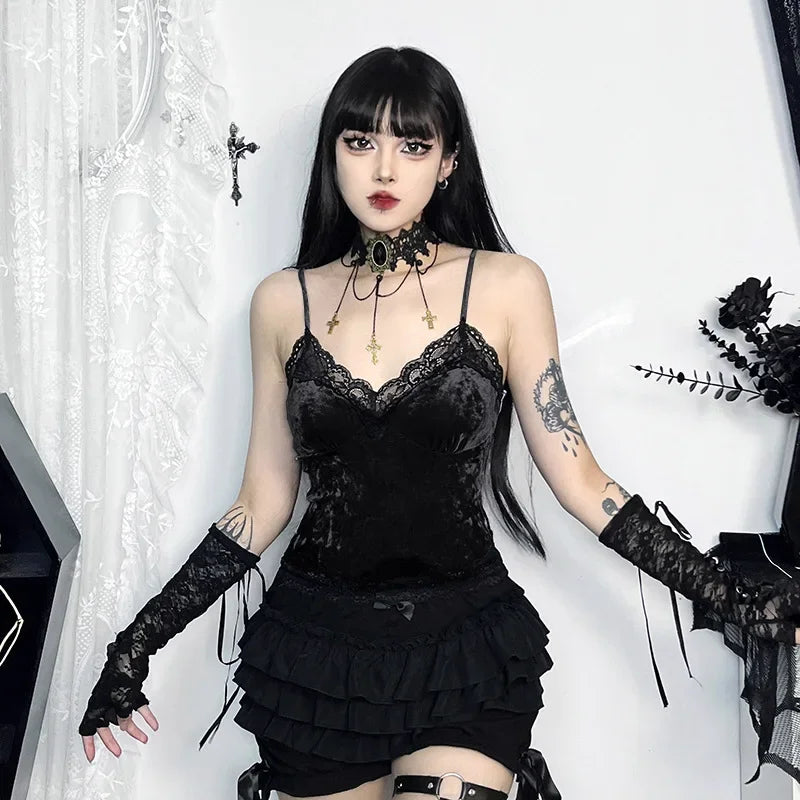 Black version of the lace-trim camisole worn with a ruffled skirt, long lace arm warmers and a cross-chain choker against white lace curtains.