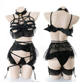 Front and rear mannequin views of the black pentagram lingerie set, including the bow-front lace top, small bat wings, ruffled waist layer, briefs, leg garters and bell choker.