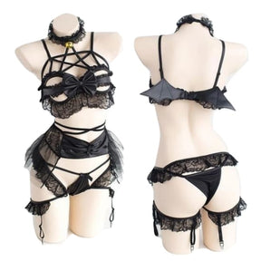 Two mannequin views of the black bat-wing lingerie set, showing the star-shaped chest straps and small wings across the back.