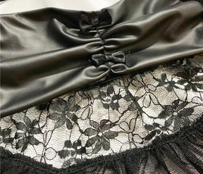 Detail of the lingerie set’s glossy ruched waist panel, small bows and floral lace ruffle.