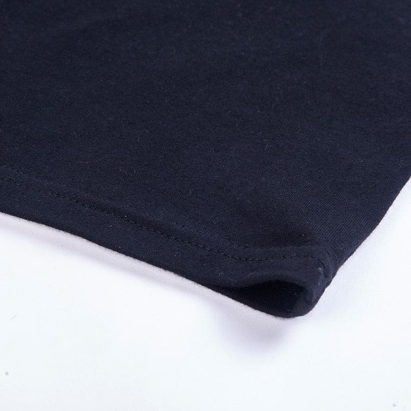 Close-up of the black mini dress hem, showing the folded edge and parallel stitching.