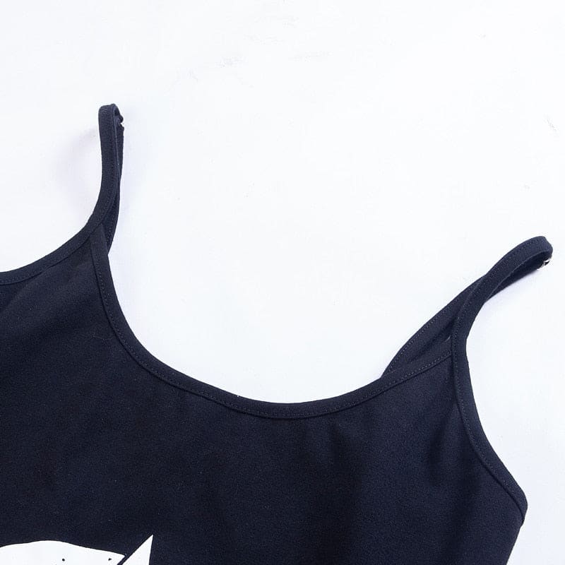 Flat close-up of the black dress scoop neckline and spaghetti straps, with the top of the white print visible below.