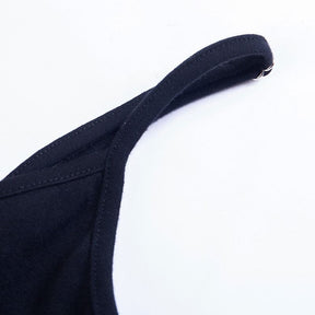 Close-up of a narrow black shoulder strap and small ring fitting on the pentagram bodycon dress.