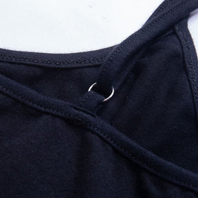 Close-up of the black dress strap attachment ring and stitching along the rounded back neckline.