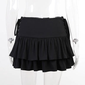 Front clear-mannequin view of the black ruffle skirt, showing the wide waistband and laced panels at both sides.