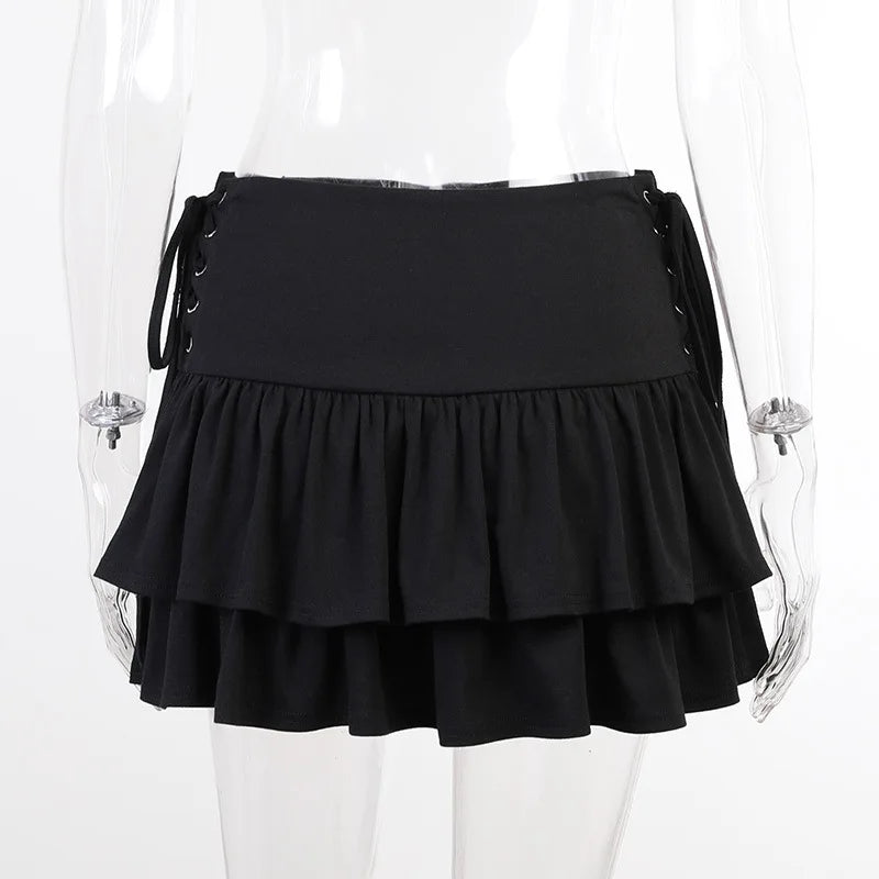 Front clear-mannequin view of the black ruffle skirt, showing the wide waistband and laced panels at both sides.