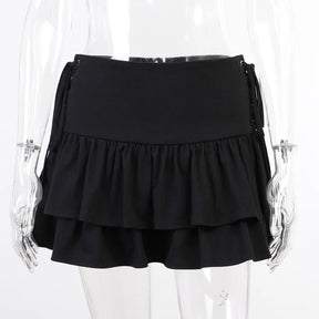 Black ruffle mini skirt on a clear mannequin from the back, showing a plain waistband above two gathered tiers.