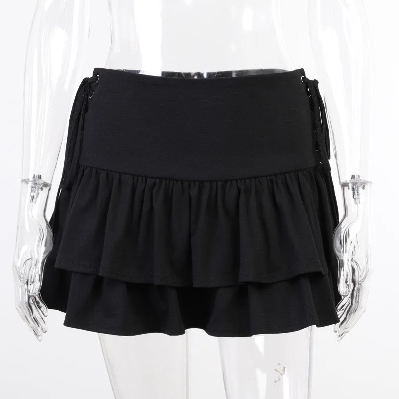Black ruffle mini skirt on a clear mannequin from the back, showing a plain waistband above two gathered tiers.